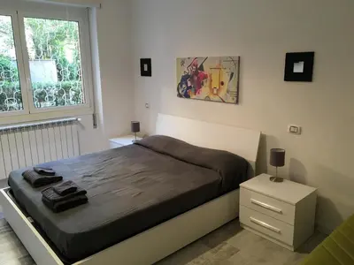 a bedroom with a large bed and a window at OASI METROPOLITANA Apartment in Rome