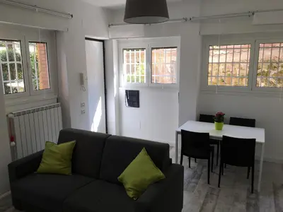 a living room with a couch and a table at OASI METROPOLITANA Apartment in Rome