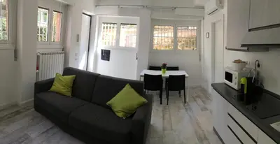 a living room with a couch and a table at OASI METROPOLITANA Apartment in Rome
