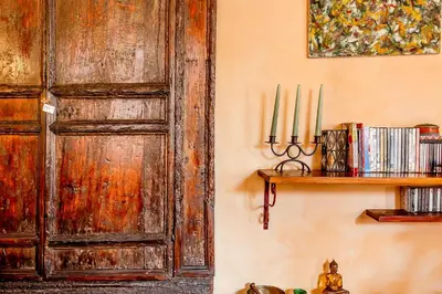 an old wooden door in a room with a shelf at Charming Bright Colosseum apartment in Rome