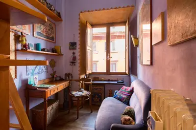 a living room with a couch and a desk and a window at Charming Bright Colosseum apartment in Rome