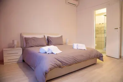 a bedroom with a bed with two towels on it at San Silverio Luxury House in Rome