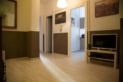 a living room with a flat screen tv and a living room with a floor at San Silverio Luxury House in Rome