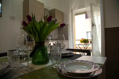 a table with a vase of purple tulips on it at San Silverio Luxury House in Rome