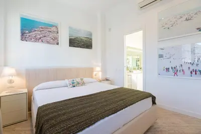 a bedroom with a bed and two pictures on the wall at Amazing Penthouse Piazza Venezia in Rome