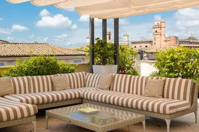 a living room with a couch and an umbrella at Amazing Penthouse Piazza Venezia in Rome
