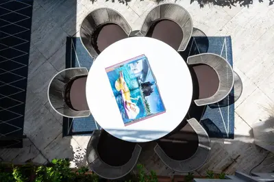 a table with a picture on it on a bench at Amazing Penthouse Piazza Venezia in Rome