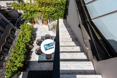 an overhead view of a table and chairs on a stairs at Amazing Penthouse Piazza Venezia in Rome