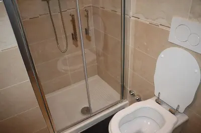 a bathroom with a shower and a toilet at R.T. HOUSE'S in Rome