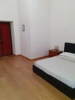 a bedroom with a bed and a red door at R.T. HOUSE'S in Rome