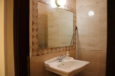 a bathroom with a sink and a mirror at R.T. HOUSE'S in Rome