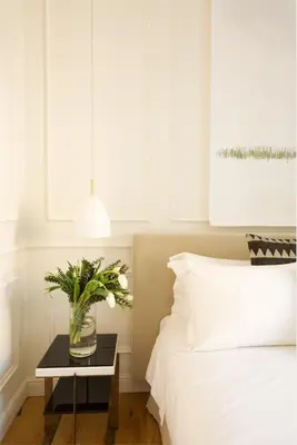 a bedroom with a bed and a table with a vase of flowers at Parisii Luxury Relais Rome in Rome