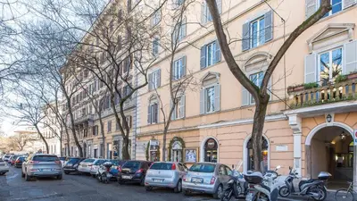 a row of cars parked in front of a building at Rental in Rome Pompeo Magno in Rome