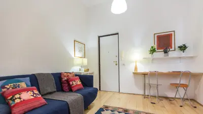 a living room with a blue couch and a table at Rental in Rome Pompeo Magno in Rome