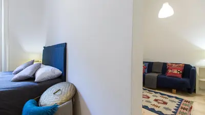 a living room with a bed and a couch at Rental in Rome Pompeo Magno in Rome
