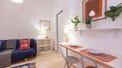 a living room with a blue couch and a table at Rental in Rome Pompeo Magno in Rome