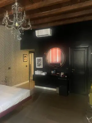 a bedroom with a bed and a chandelier at Frattina 57 in Rome