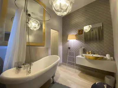 a bathroom with a white tub and a sink at Frattina 57 in Rome