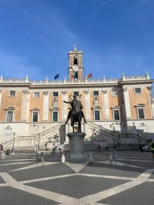 a statue in front of a building with a clock tower at Frattina 57 in Rome