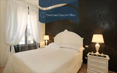 a bedroom with a white bed and a window at Daplace - HQH Colosseo in Rome