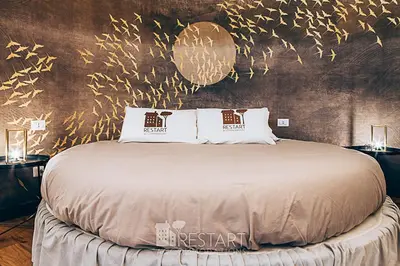 a bedroom with a large bed with gold decorations at Restart Accommodations Ada in Rome