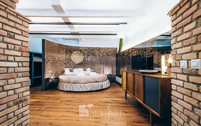 a bedroom with a bed and a brick wall at Restart Accommodations Ada in Rome