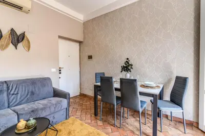 a living room with a couch and a table and chairs at Maison Babuino in Rome