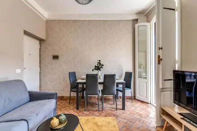 a living room with a couch and a table and chairs at Maison Babuino in Rome
