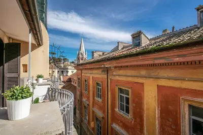 an apartment balcony with a view of a church at Maison Babuino in Rome