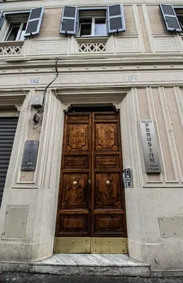a building with a large wooden door on it at Relais Forus Inn in Rome