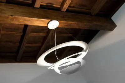 a white chandelier hanging from a wooden ceiling at Relais Forus Inn in Rome