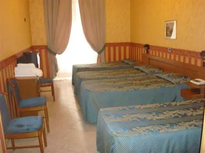 a hotel room with two beds and a table and chairs at Hotel Demetra Capitolina in Rome