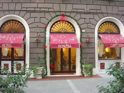 a store front with pink awnings on the windows at Hotel Demetra Capitolina in Rome