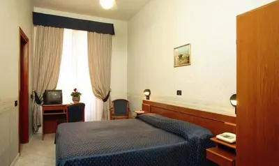 a hotel room with a blue bed and a desk at Hotel Demetra Capitolina in Rome