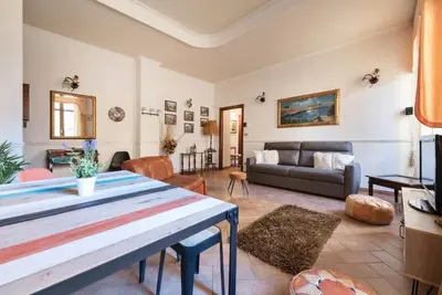 a living room with a couch and a table at Re Di Roma Vintage Apartment in Rome