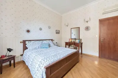 a bedroom with a bed and two tables and a door at Re Di Roma Vintage Apartment in Rome