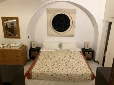 a bedroom with a bed and a round window at Elly's Loft in Rome
