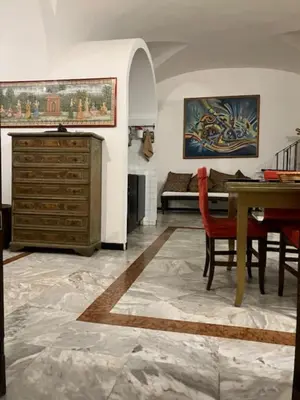 a living room with a table and a bedroom at Elly's Loft in Rome