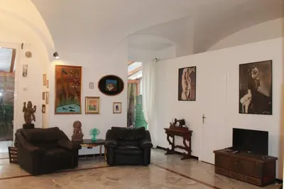 a living room with two chairs and a tv at Elly's Loft in Rome