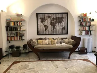 a living room with a couch and bookshelves at Elly's Loft in Rome