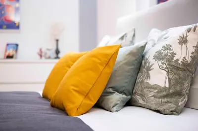 a group of pillows sitting on top of a bed at Casa Paola Guesthouse in Rome