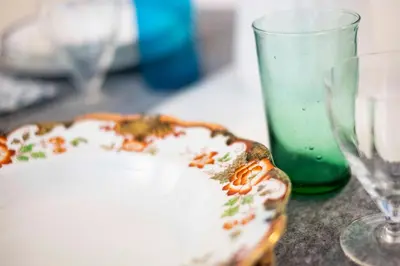 a table with a plate and a glass on it at Casa Paola Guesthouse in Rome