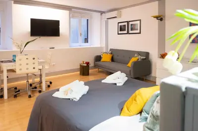 a living room with a bed and a couch at Casa Paola Guesthouse in Rome