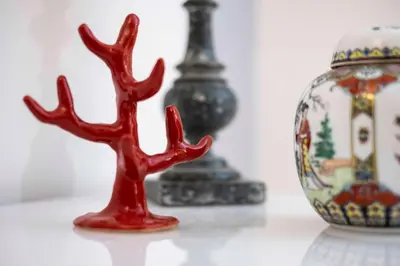 a red antler statue sitting next to a vase at Casa Paola Guesthouse in Rome