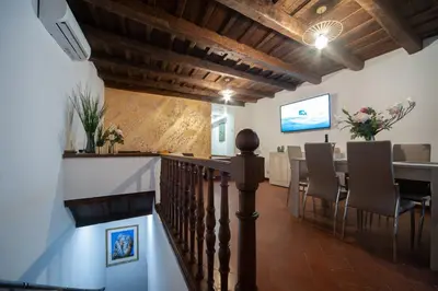a dining room with a staircase and a table with chairs at Navona Jacuzzi Apartment in Rome
