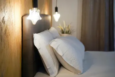 a pile of pillows on a bed in a room at Navona Jacuzzi Apartment in Rome