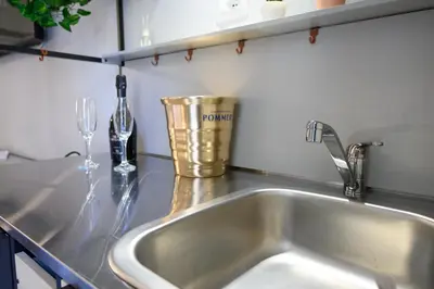 a kitchen counter with a stainless steel kitchen sink at GuestHouse o Affittacamere Magenta Baylon Suite B in Rome