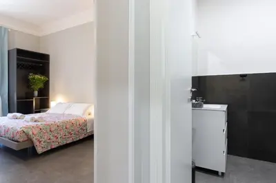 a bedroom with a bed and a room with a bathroom at GuestHouse o Affittacamere Magenta Baylon Suite B in Rome