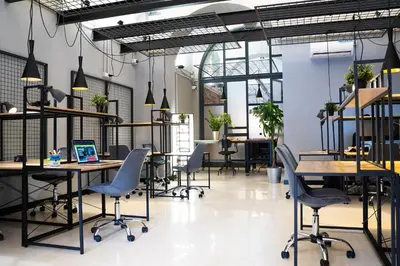 a large room with tables and chairs and windows at YellowSquare Rome in Rome