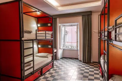 a room with four bunk beds and a window at YellowSquare Rome in Rome